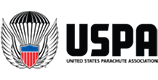 Logo of the United States Parachute Association. It features a stylized parachute design with a red and blue shield centered below it and "USPA" written to the right of the emblem in bold letters.