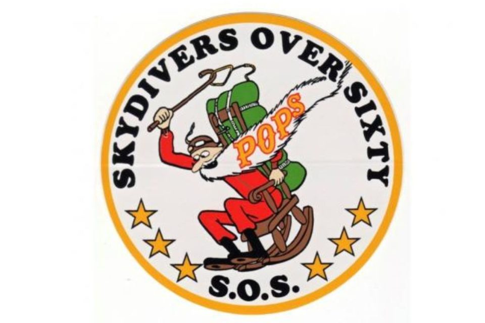 A logo featuring a cartoon Santa Claus skydiving with a green parachute and the word "POPS" on his suit. The text "Skydivers Over Sixty S.O.S." encircles the image, with stars at the bottom.